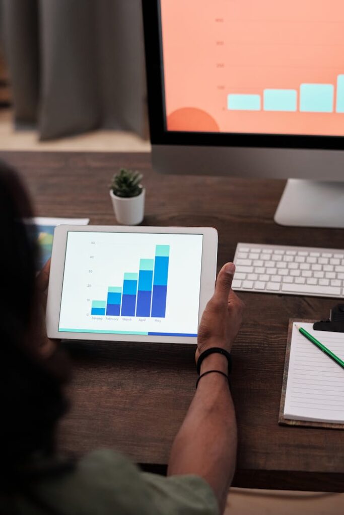 Crafting Captivating Headlines: Your awesome post title goes here A person reviews statistical graphs on a tablet, showcasing data analysis and technology.